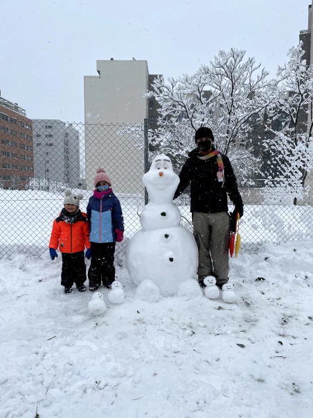 William Viana and family building a snowman