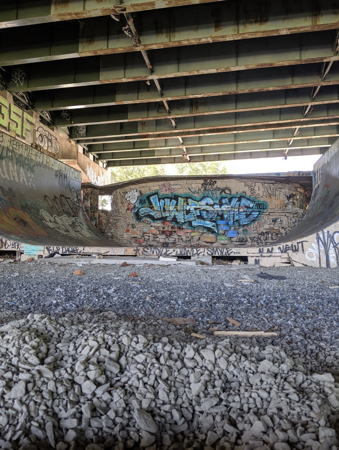 skate ramps underneath a bridge
