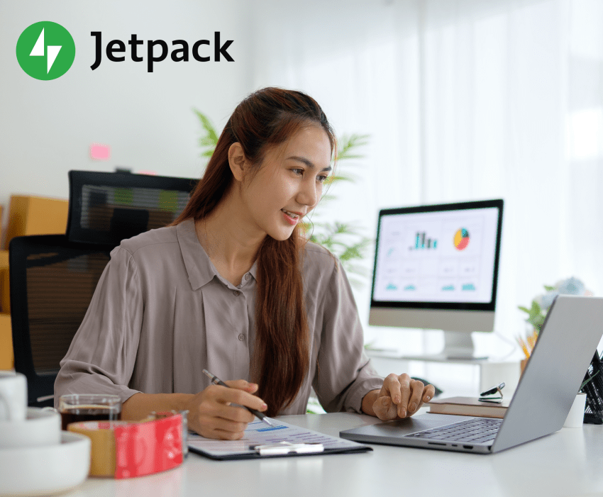 woman working at a computer, reviewing analytics