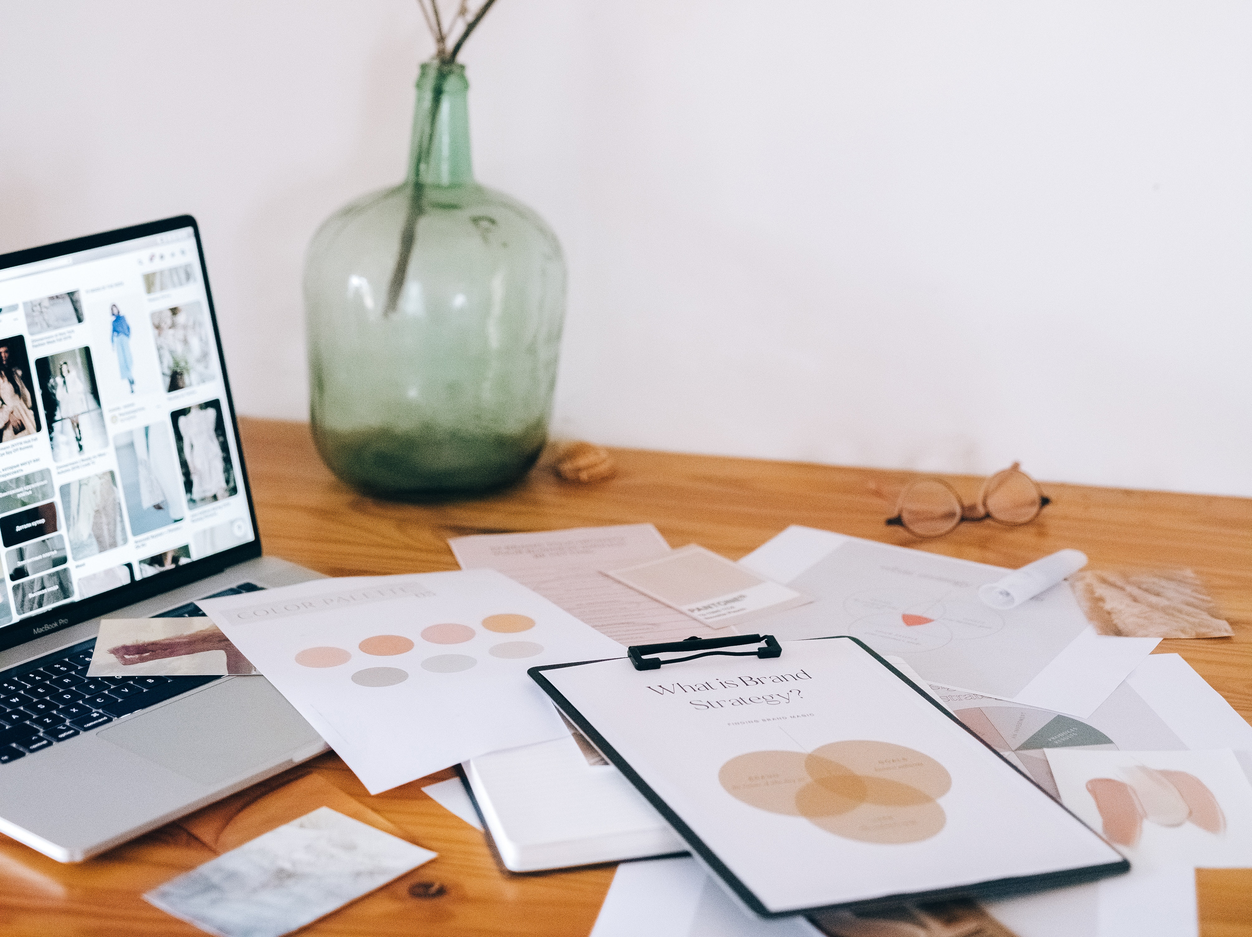 brand color options on a table in front of a laptop with Pinterest on the screen