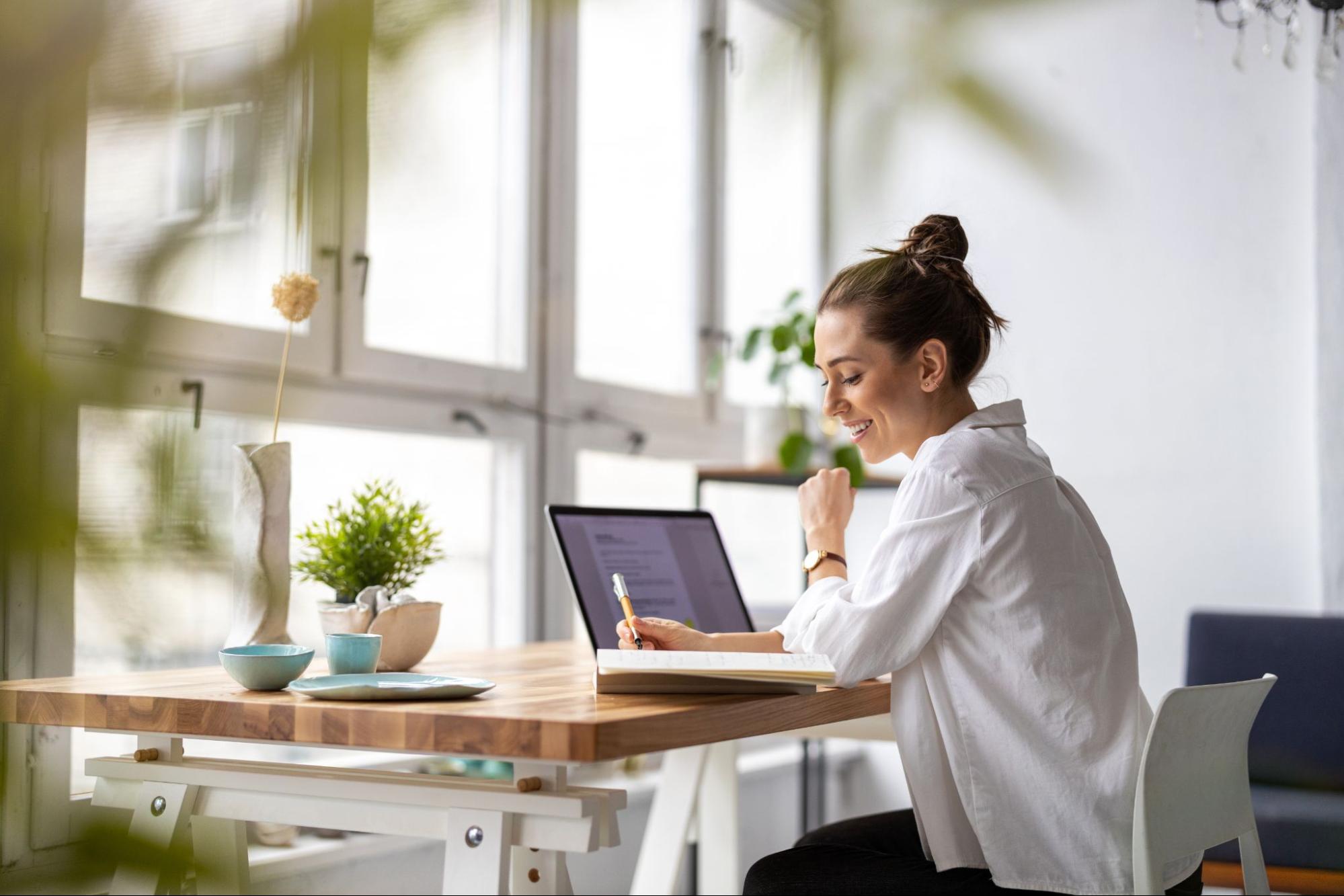 woman working at her kitchen table