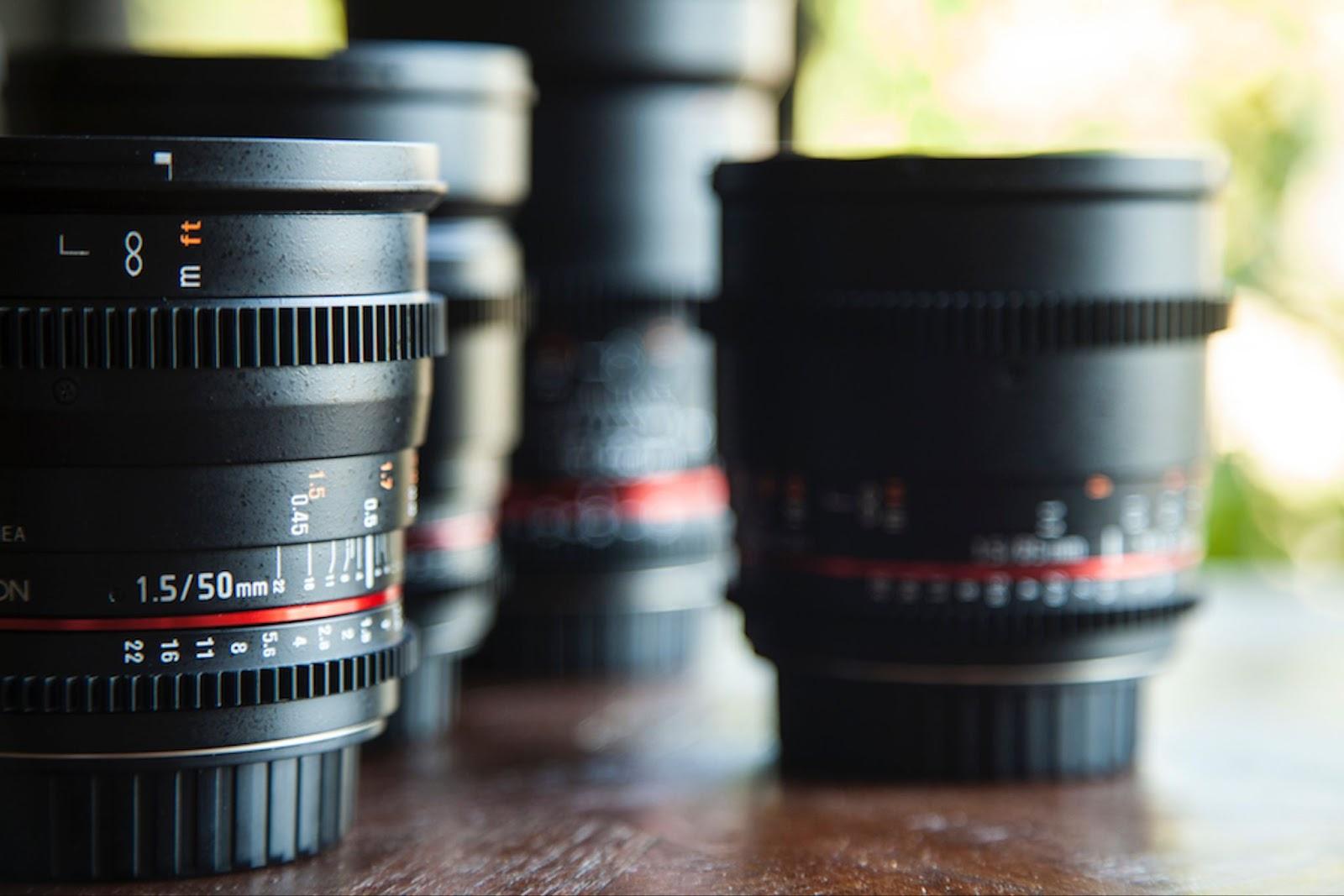 several camera lenses on a table