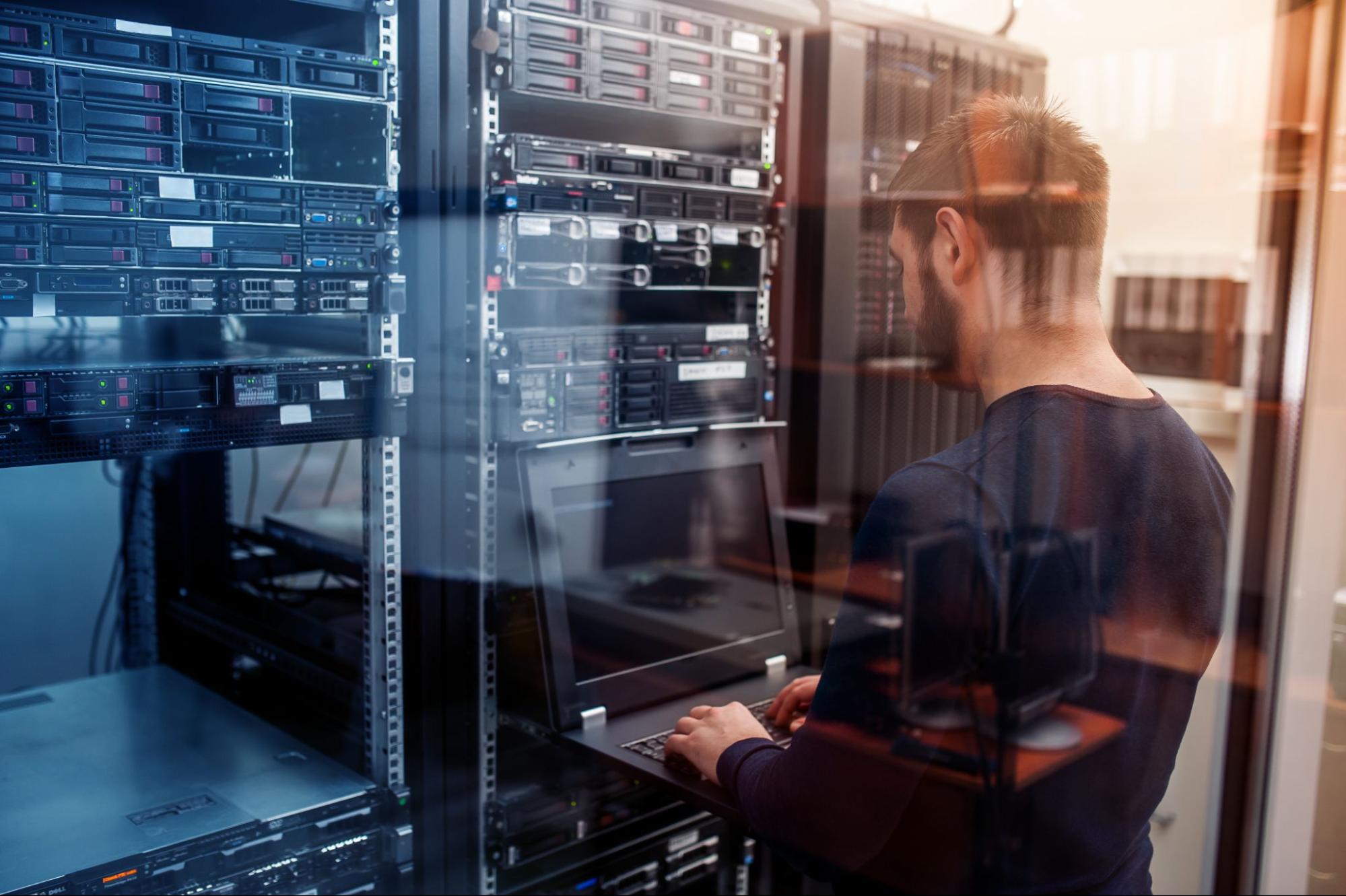 IT worker in a room of servers