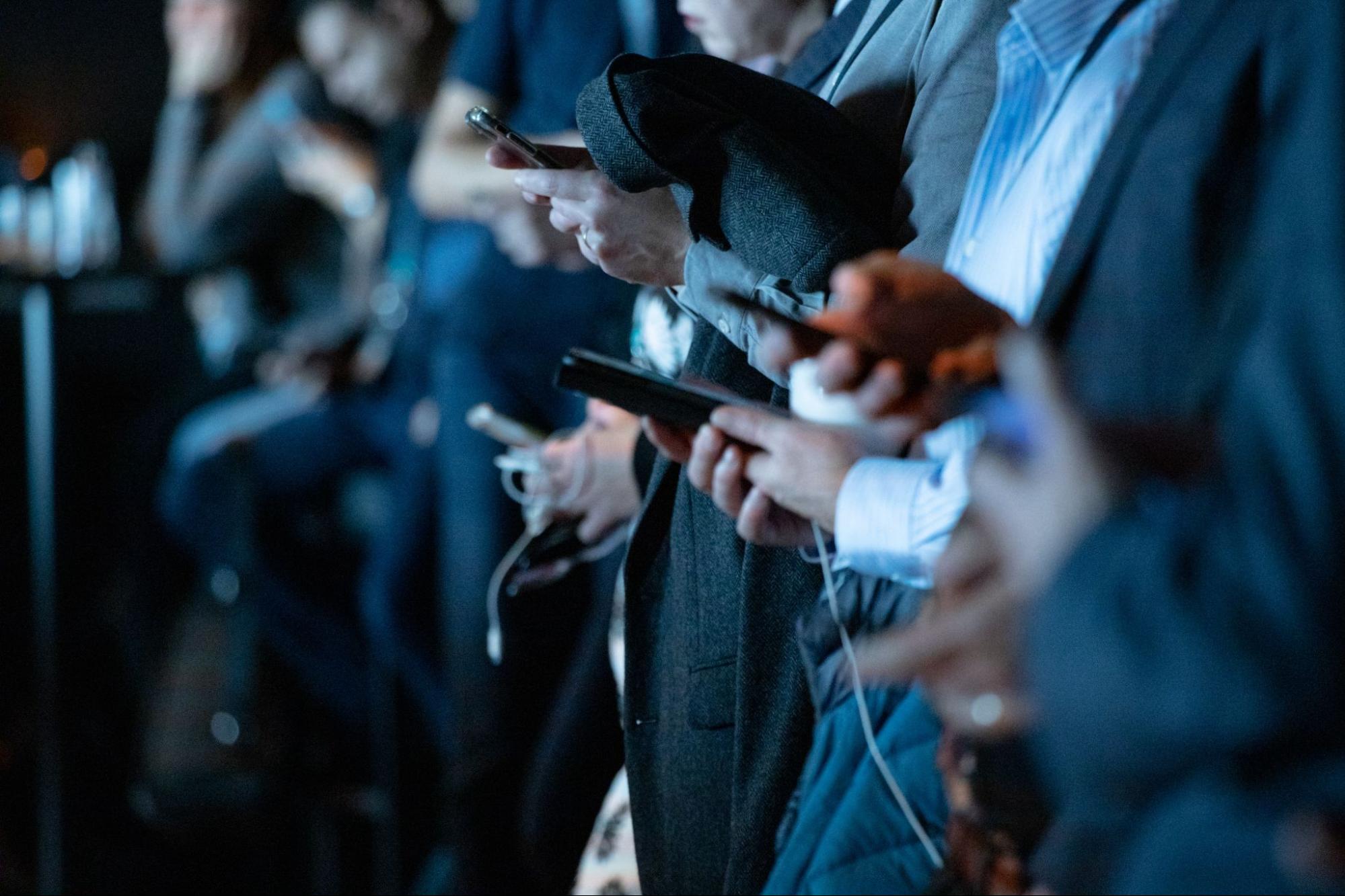 Crowd of people using mobile devices.