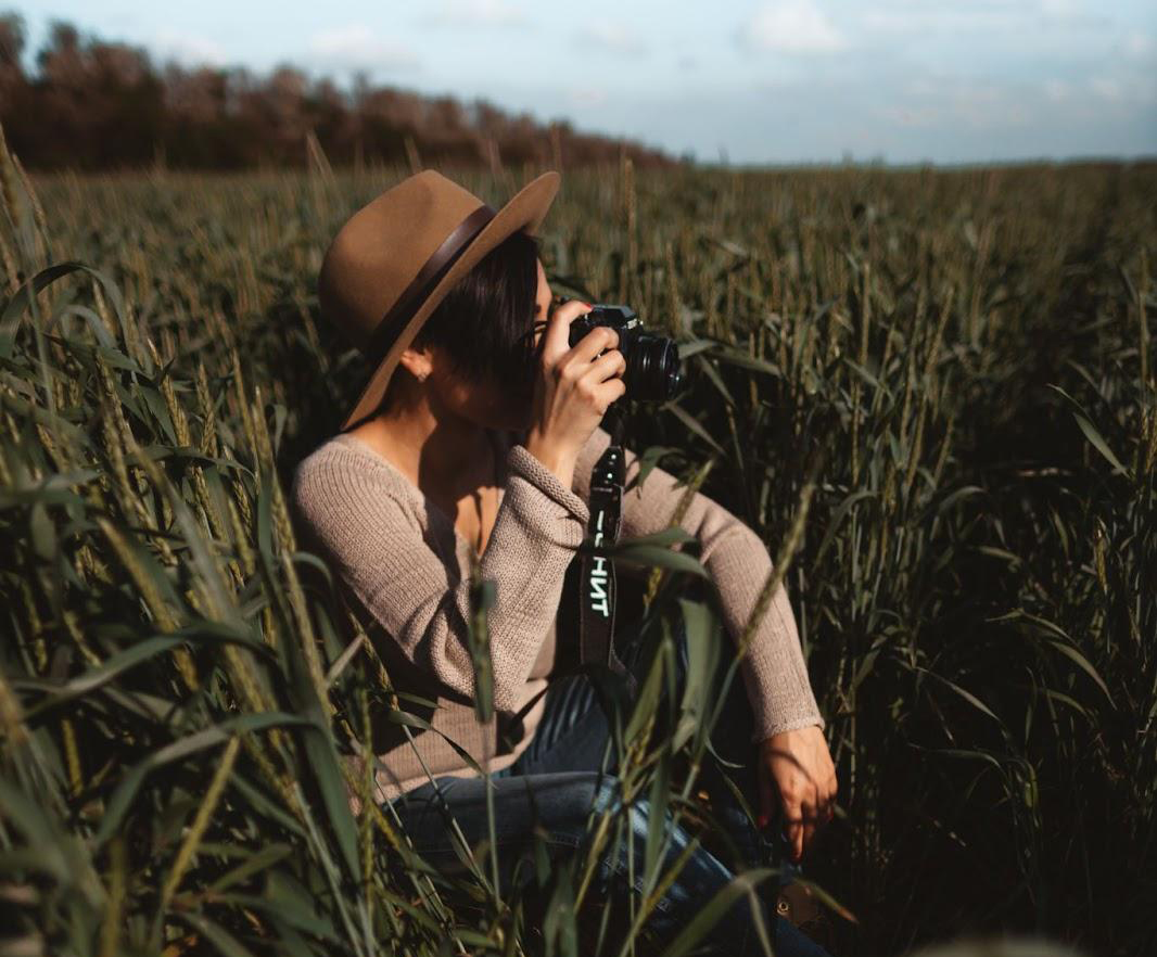photographer taking nature pictures in a field