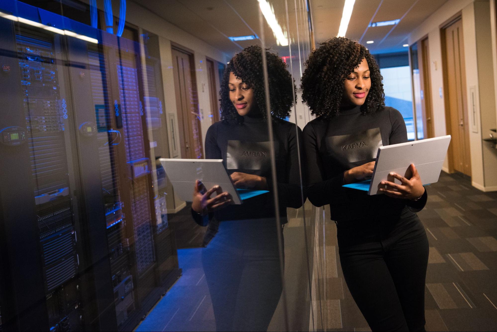 woman working on a laptop in a server room