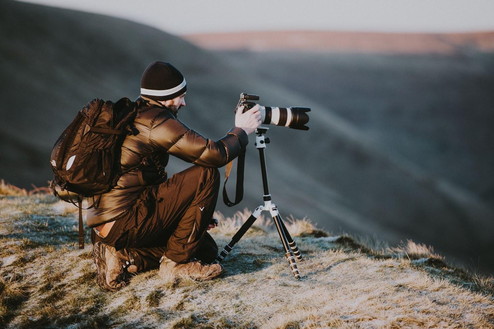 photographer setting up a shot on a mountain