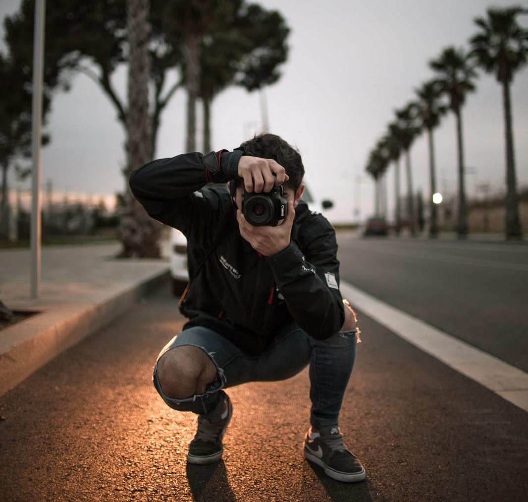photographer taking a photo in a street