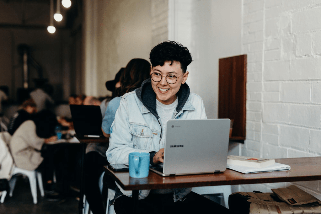 person using a laptop at a coffee shop
