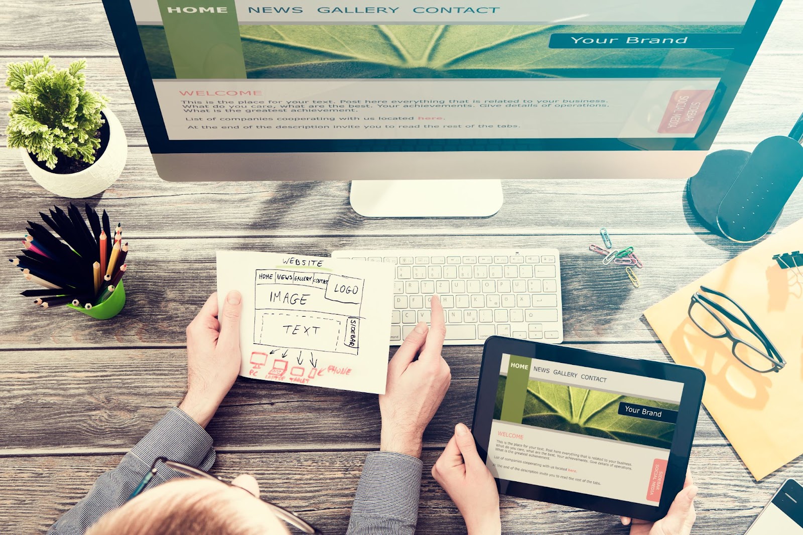 woman working on a website on a computer and tablet
