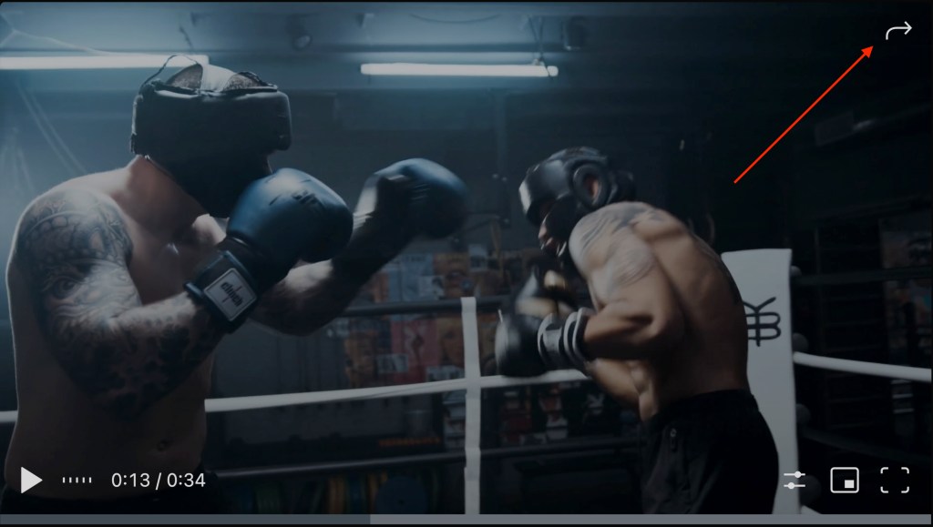 A screen-capture of the Jetpack VideoPress player, with an arrow pointing to the white share arrow in the top right corner of the screen. 