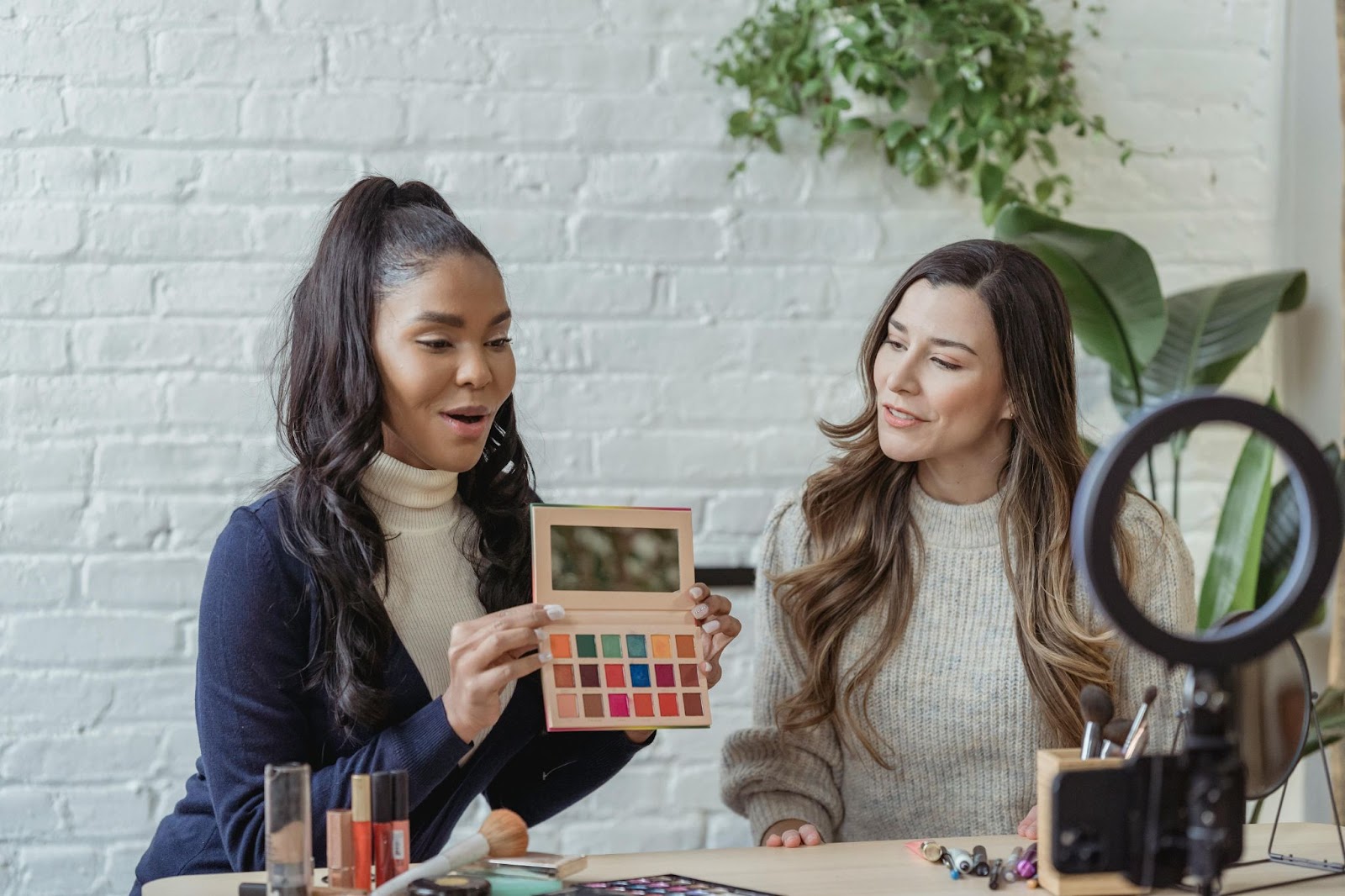 two women going live on social media and reviewing makeup