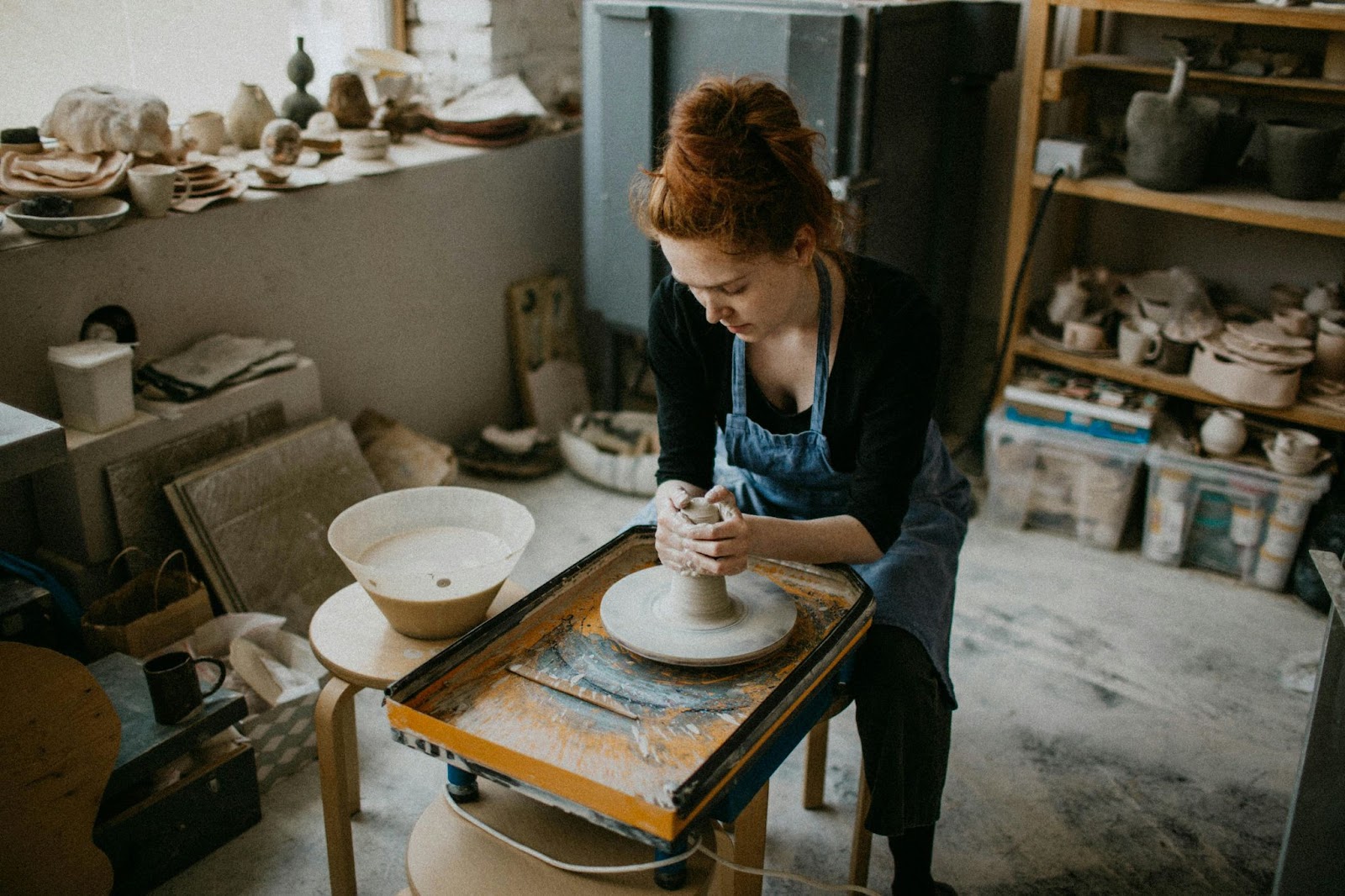 artist working with clay