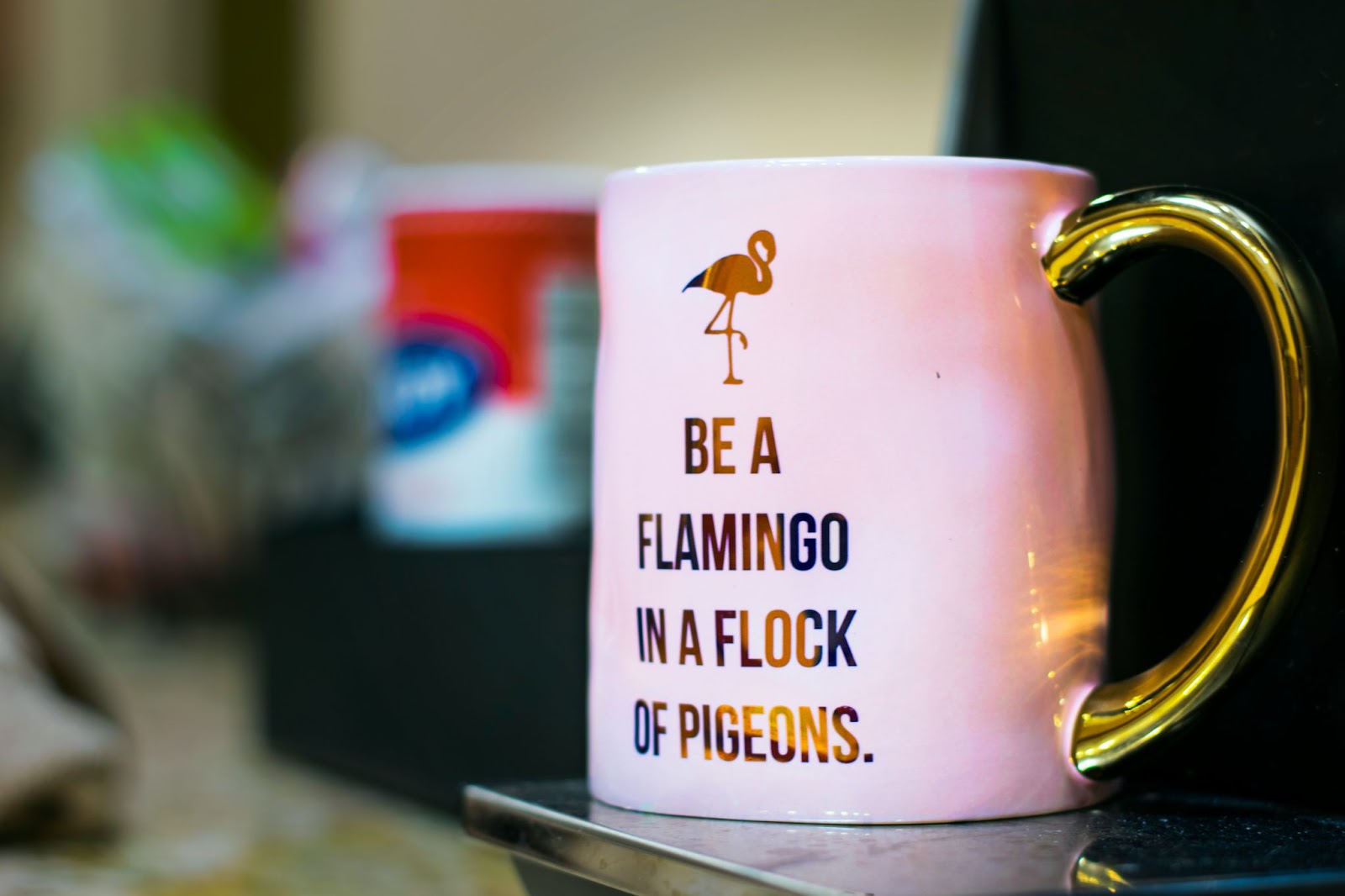 mug that says "be a flamingo in a flock of pigeons"