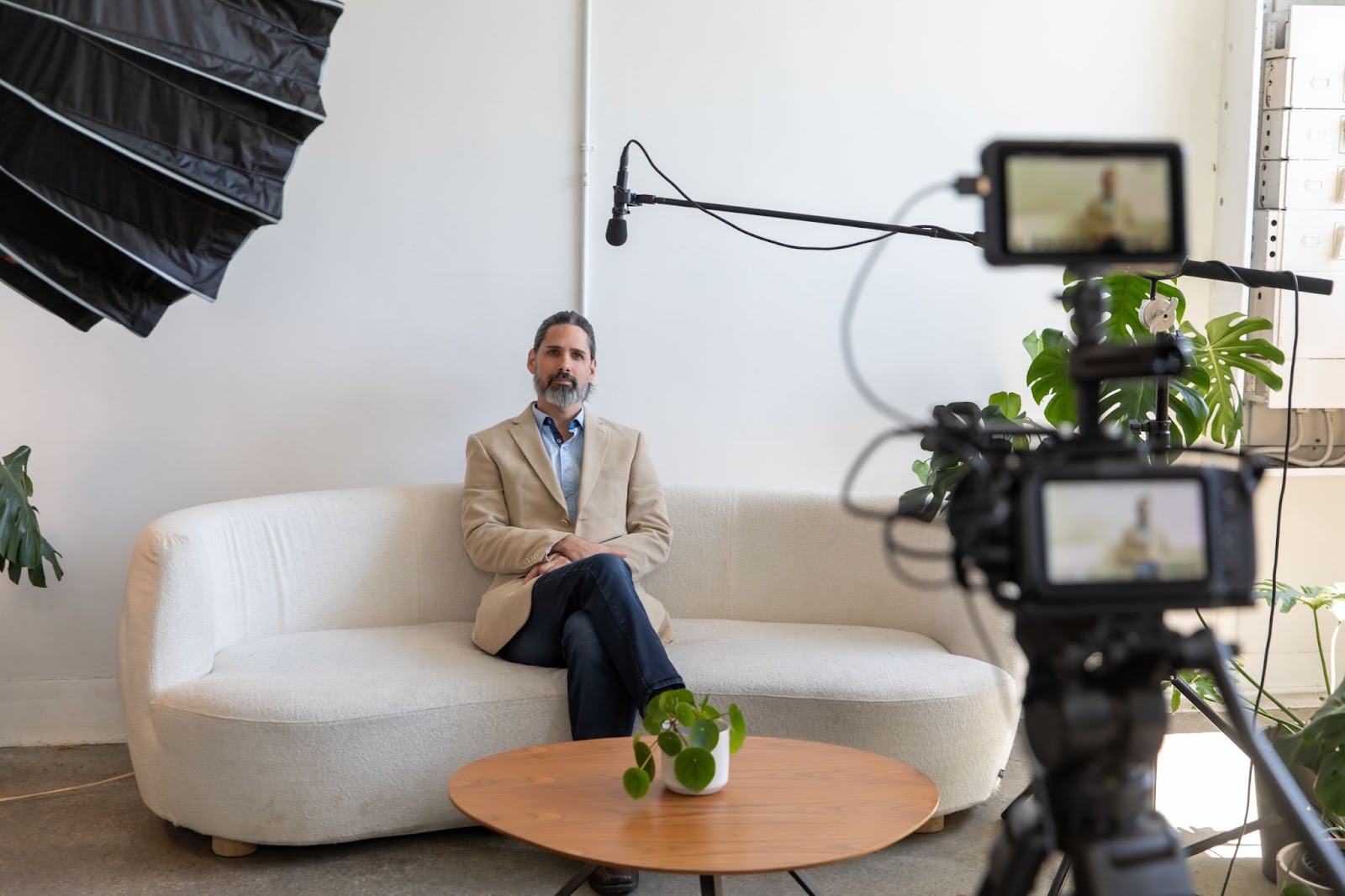 man sitting on a couch for an interview