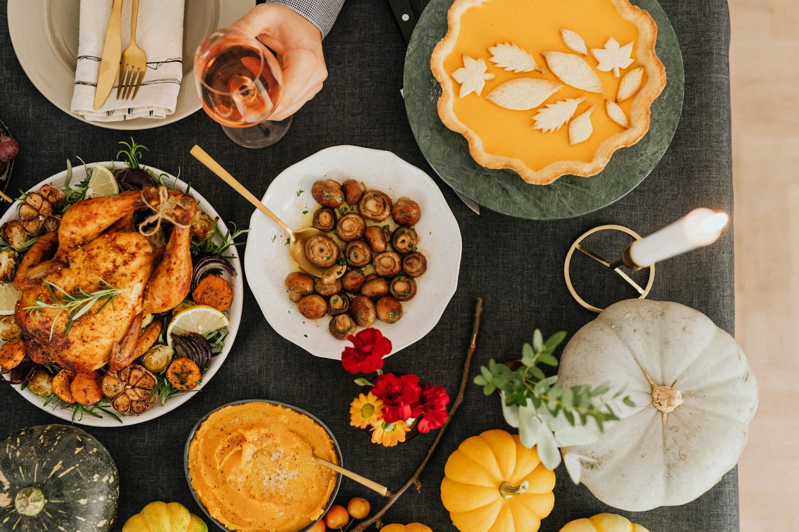 Thanksgiving table with turkey, mushrooms, pie, and more dishes and decor