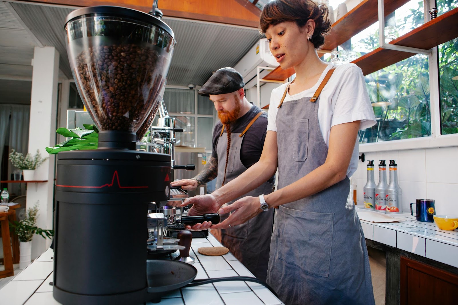 two baristas working in a coffee shop