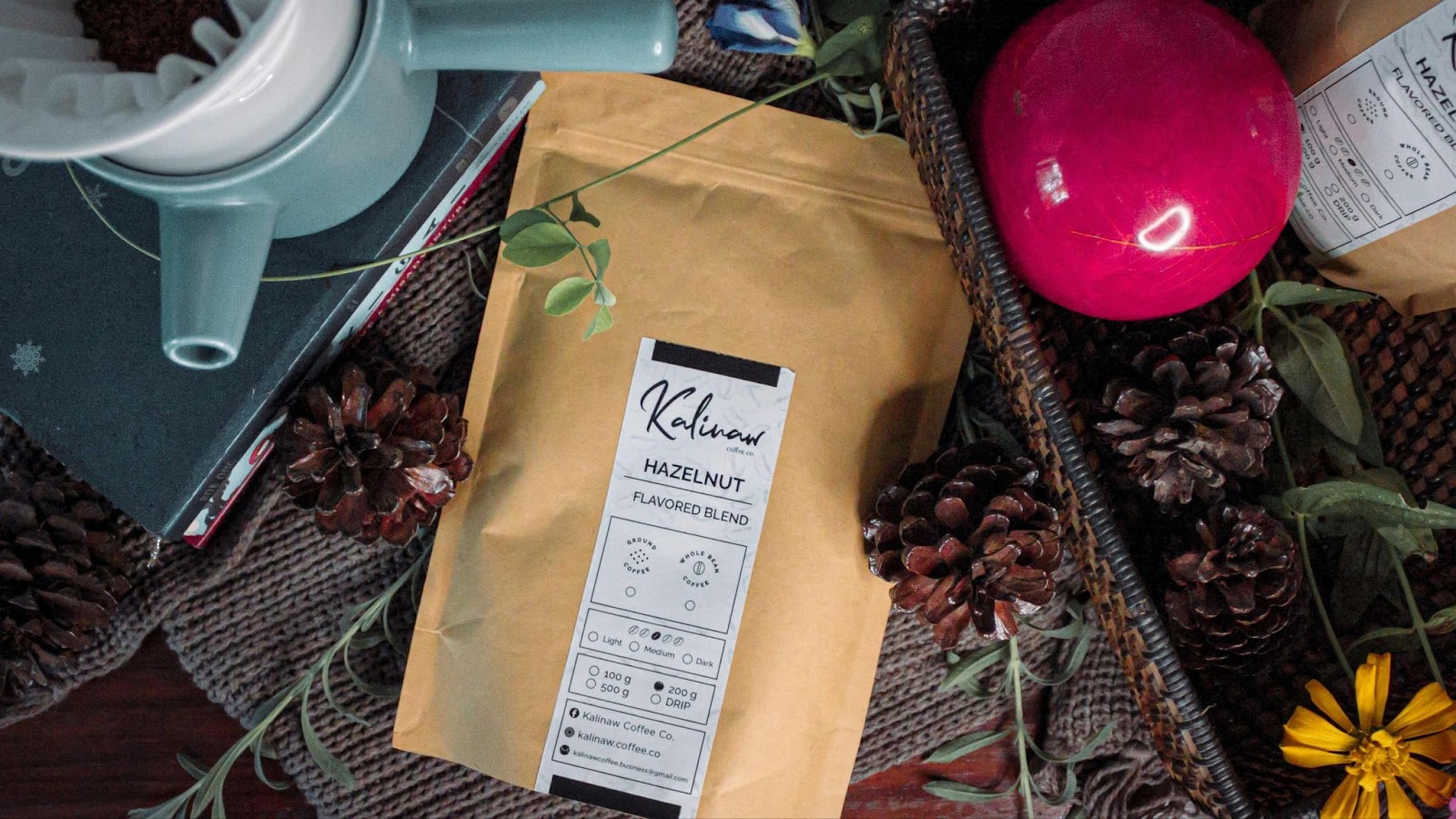 bag of coffee beans on a table, along with other coffee tools