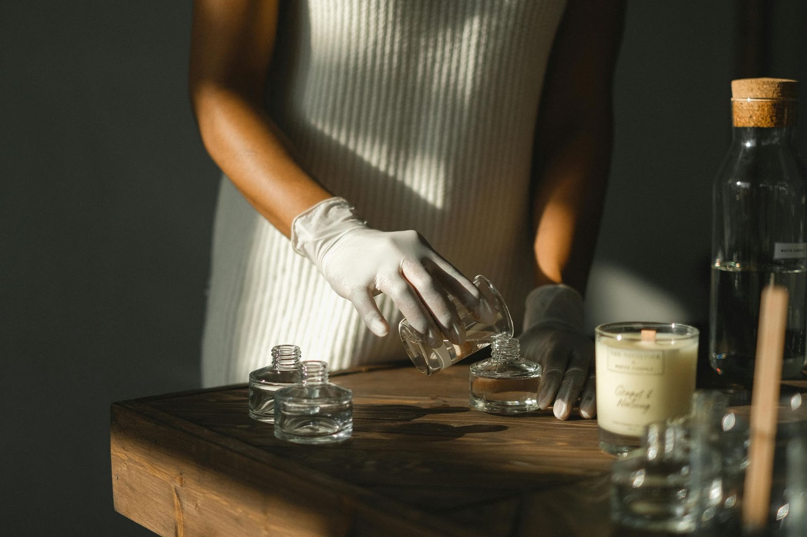 candle maker pouring wax into a container