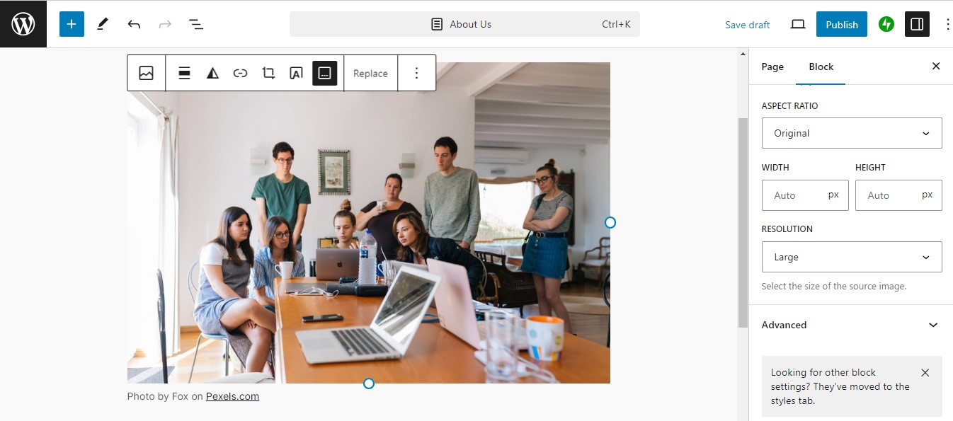 Gutenberg page editor for new page on a WordPress website with image block with an image of people gathered around a computer.