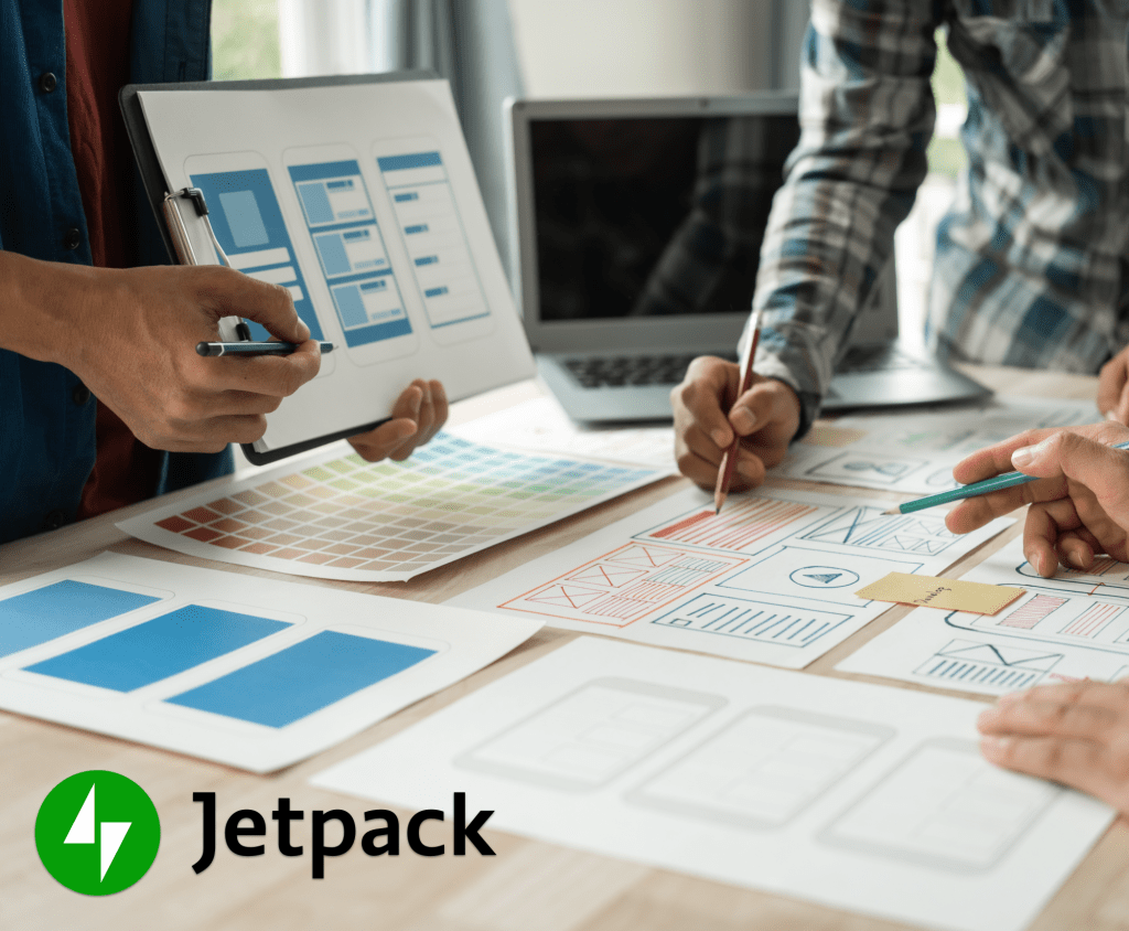 people gathered around a table working on a website mockup