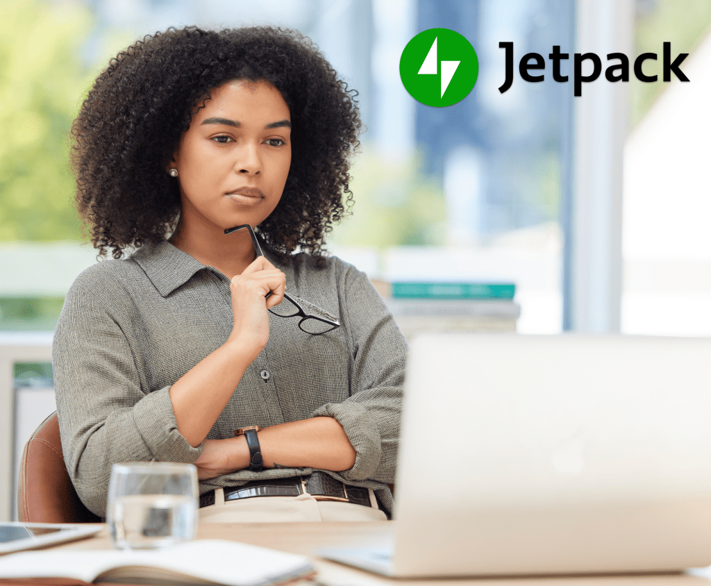 woman with glasses looking at a laptop