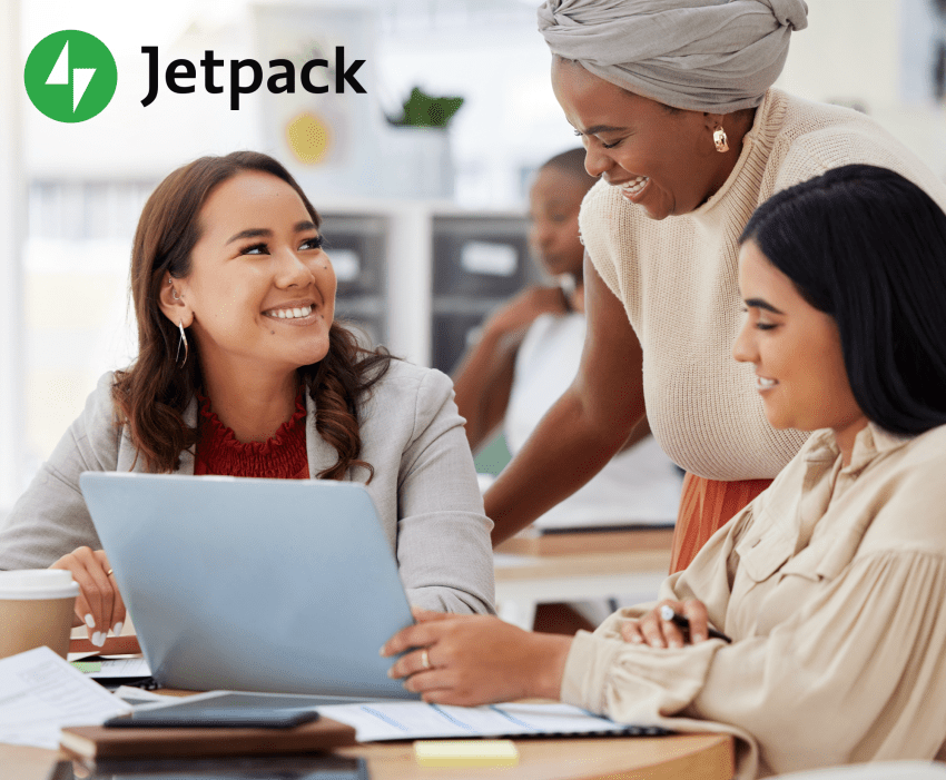 team of women working around a computer